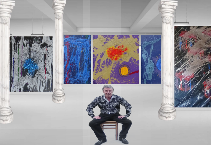 A person sit in front of four abstract artwork displayed in a gallery.