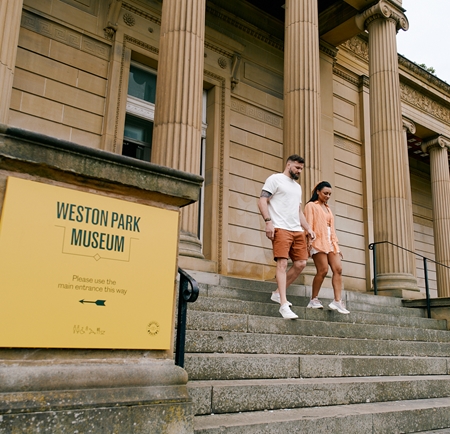A couple walk down the steps outside the Weston Park Museum in Sheffield.