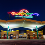 The neon sign above the entrance to Owlerton Stadium, depicting running greyhounds.