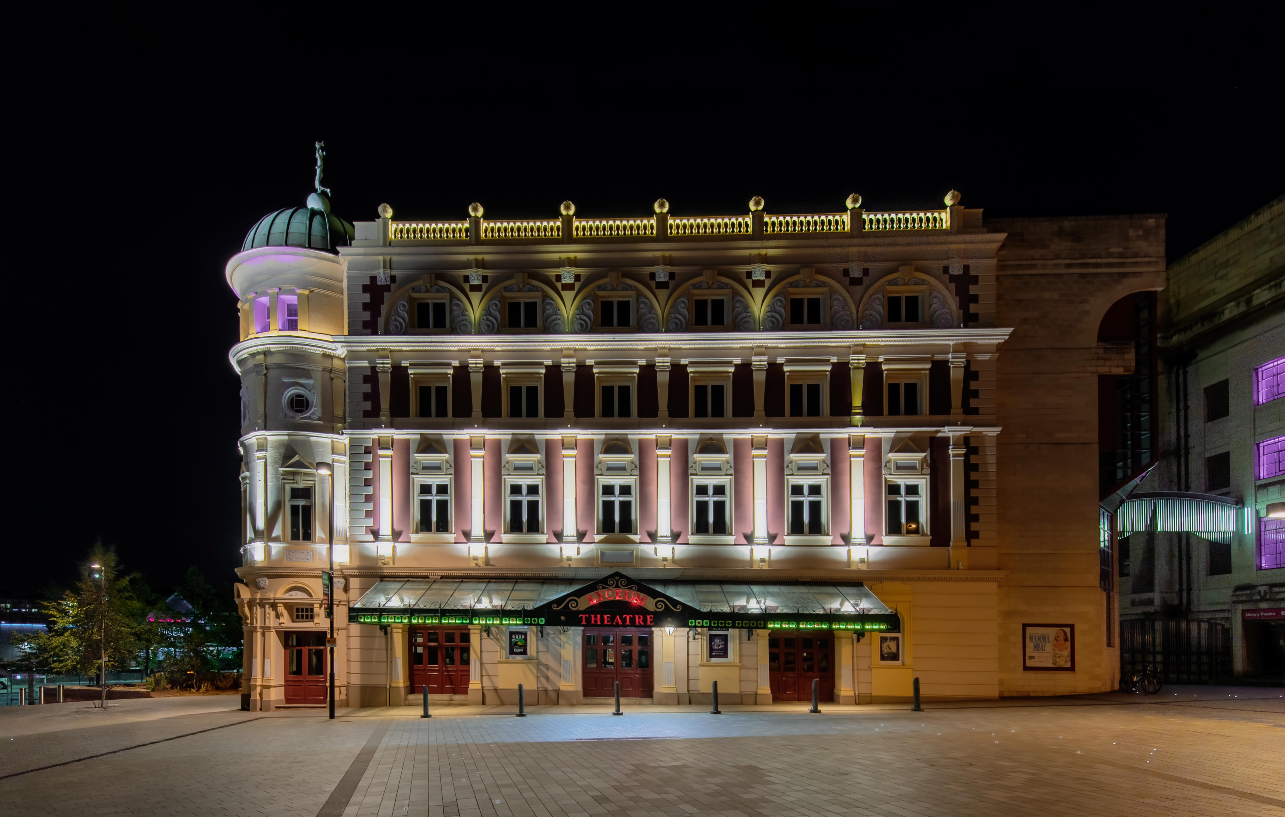 The exterior of the Lyceum Theatre all lit up, at night.