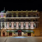 The exterior of the Lyceum Theatre all lit up, at night.