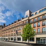 Exterior of the Radisson Blu hotel with trees in front.