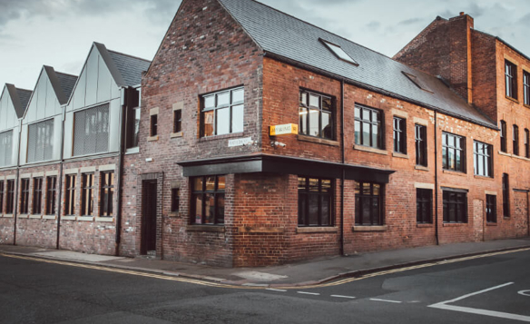 A red brick building in the centre of Sheffield, that is an old industrial building repurposed as offices.