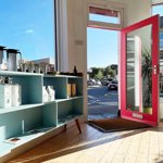 The entrance to the Corner Store through their bright red door.