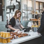 A customer at the counter, being served, at The Depot Bakery.