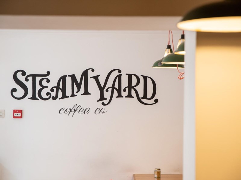 The Steam Yard logo painted on a wall.
