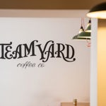 The Steam Yard logo painted on a wall.