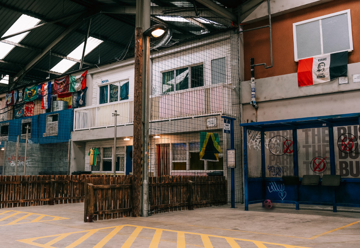 An interior shot of Yard Ball that has been made to look like an outdoor setting of a street with shops.