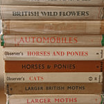 A stack of books on animal and plants.