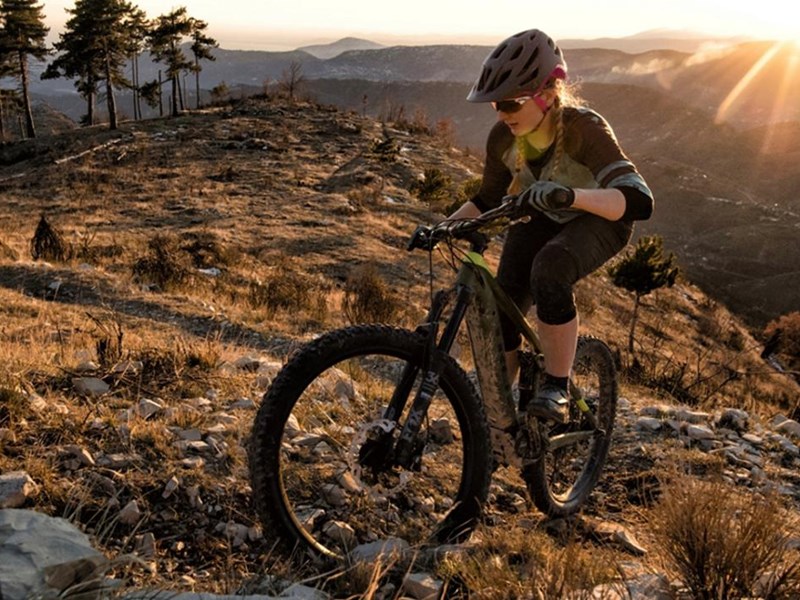 A woman peddling up a steep slope at Fox Valley on a mountain bike.