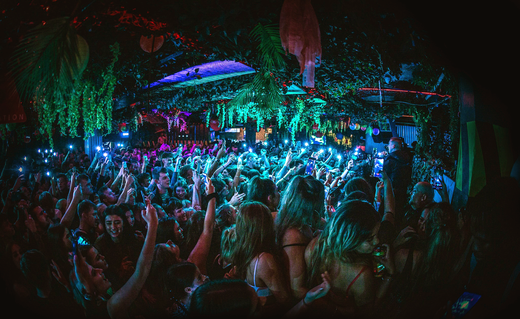 People dancing in a crowded nightclub.