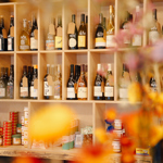 Wooden shelving filled with bottles of wine and spirits.