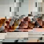 A shelf full of freshly baked bread at Bench La Cave .