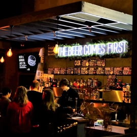 A crowd of people enjoying at night out at Triple Point Brewery.