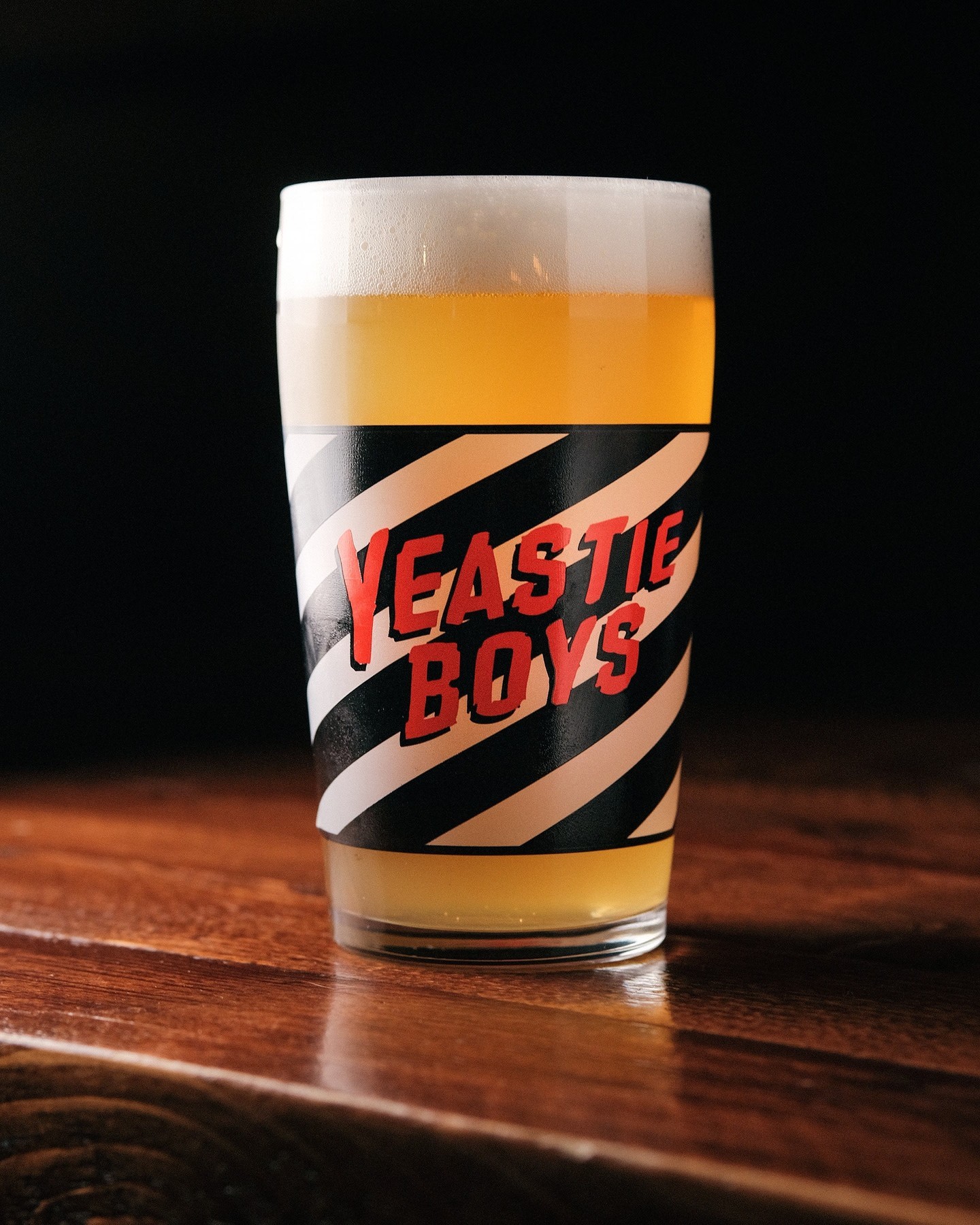 A glass of beer with the words 'Yeastie Boys' on it.