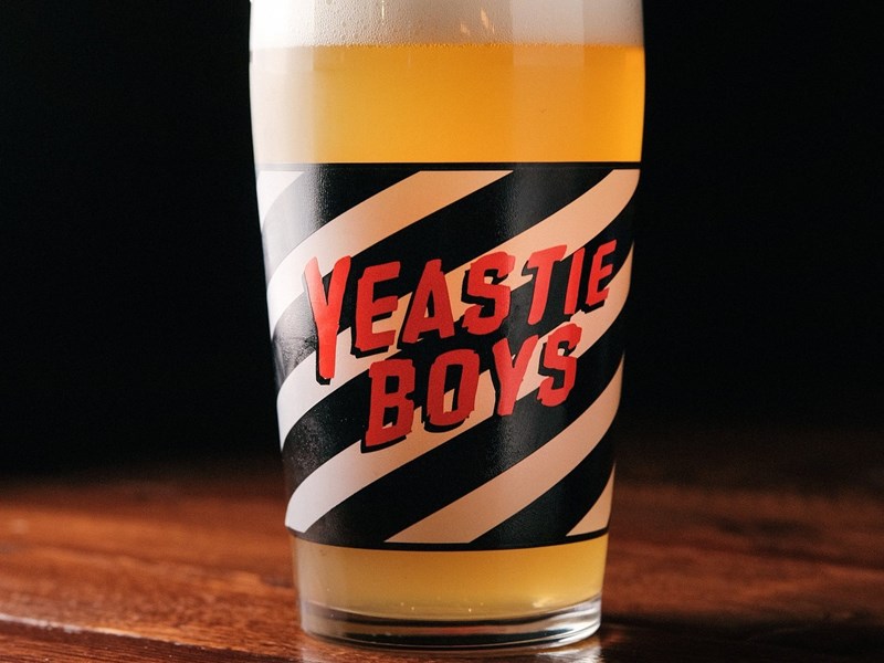 A glass of beer with the words 'Yeastie Boys' on it.