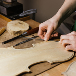 A close-up of someone making a violin.