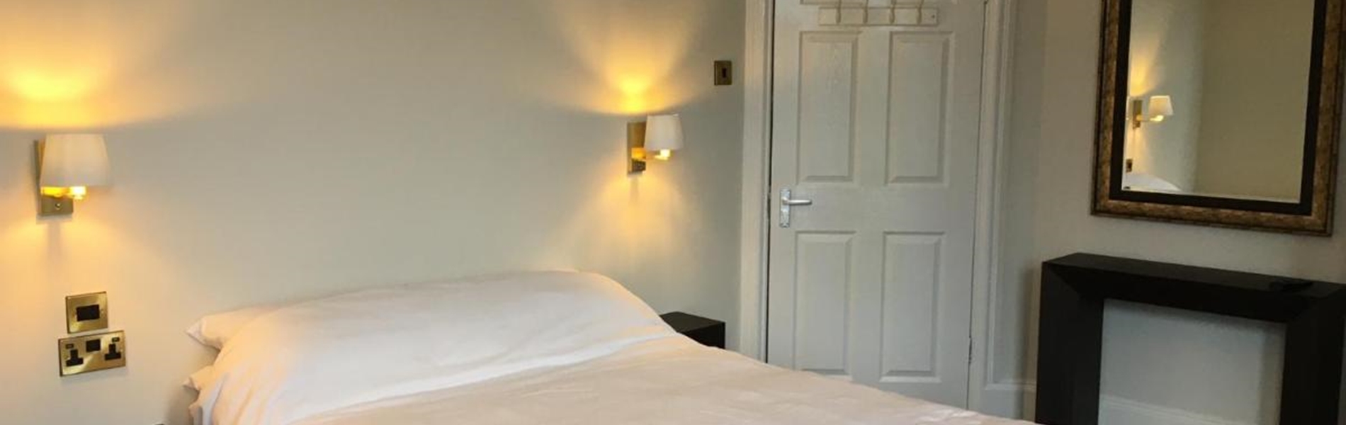 Coniston Guest House – bedroom with a double bed and bedside lights