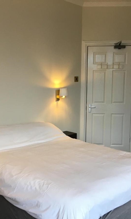 Coniston Guest House – bedroom with a double bed and bedside lights