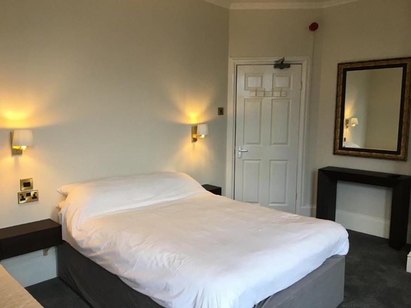 Coniston Guest House – bedroom with a double bed and bedside lights