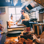 A chef is preparing food in a restaurant kitchen.
