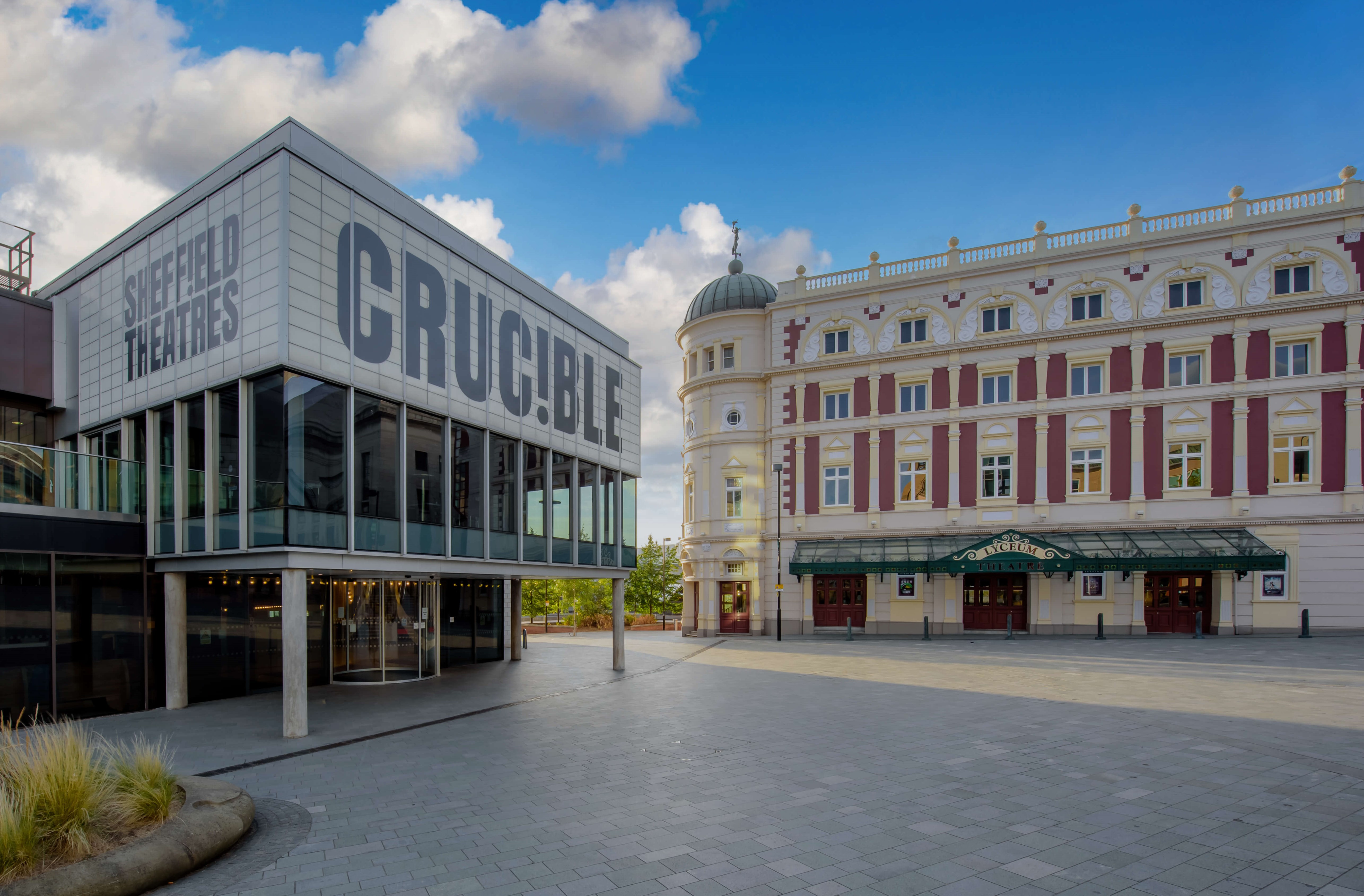 The exterior of teh Crucible Theatre, during the day, with the Lyceum Theatre in the background.