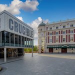 The exterior of teh Crucible Theatre, during the day, with the Lyceum Theatre in the background.