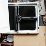 A over-head shot of a table filled with printing equipment.