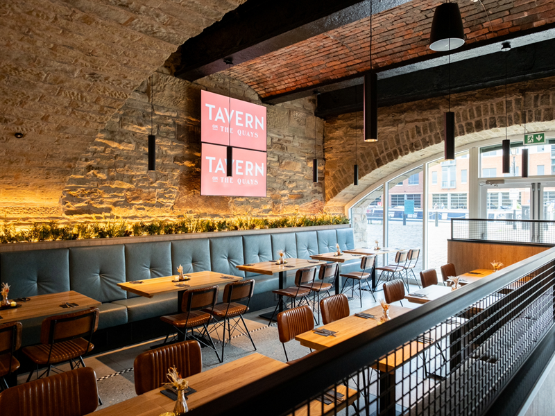 The interior of Tavern On The Quays with its bare stone walls and vaulted ceiling.
