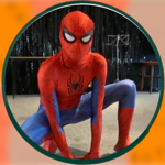 A person dressed as Spiderman, crouching on the floor.