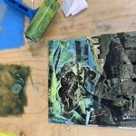 A printing plate and burnisher on a table.