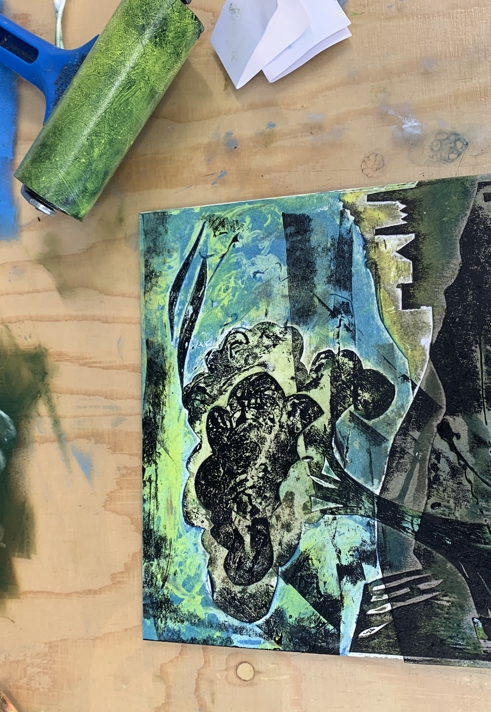 A printing plate and burnisher on a table.