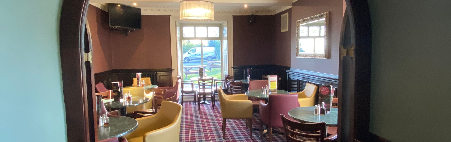 Breakfast room at Cubley Hall with tables, chairs, and natural light.