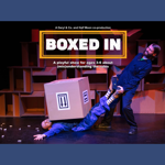 In a comedic fashion, one person is trying to pull another person out from under a huge box where they are trapped.