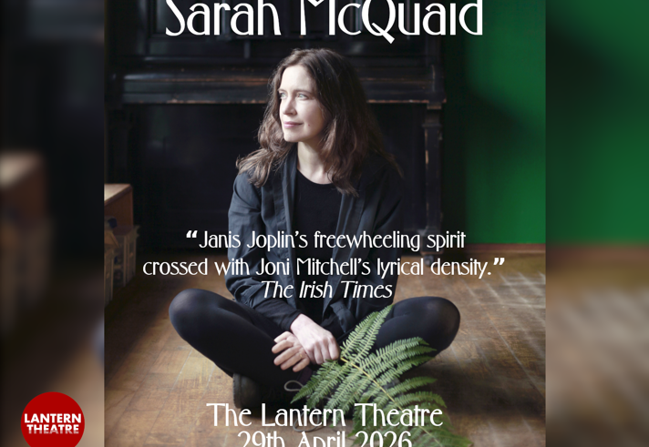 Promo image for the event, featuring Sarah McQuaid sat on a wooden floor. Behind her is an upright piano.