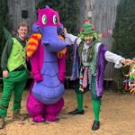 Three entertainers dressed in costumes, one as a dragon, at the Tropical Butterfly House Wildlife Conservation Park.
