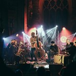A band performing in a darkened church.