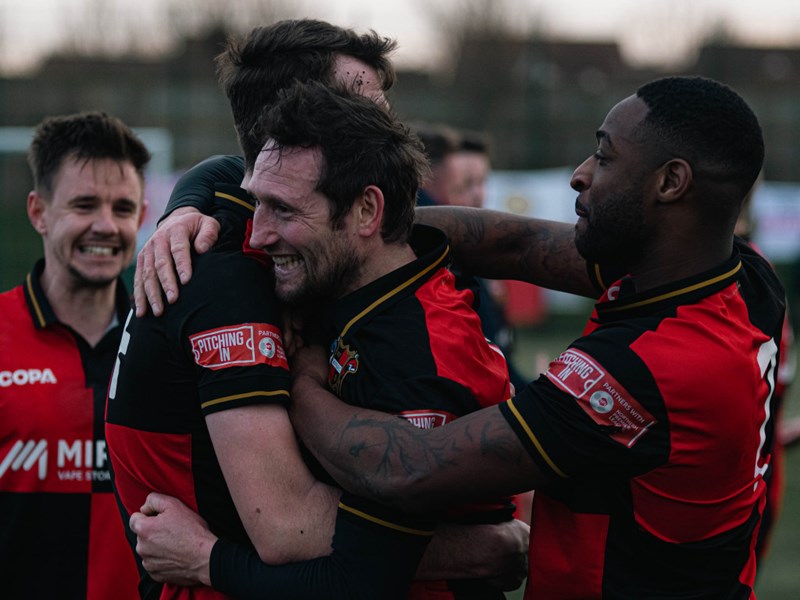 Sheffield FC players hugging.
