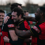 Sheffield FC players hugging.