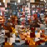 Four people enjoying a night out at Craft & Berry.