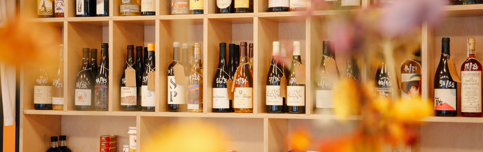 Wooden shelving filled with bottles of wine and spirits.