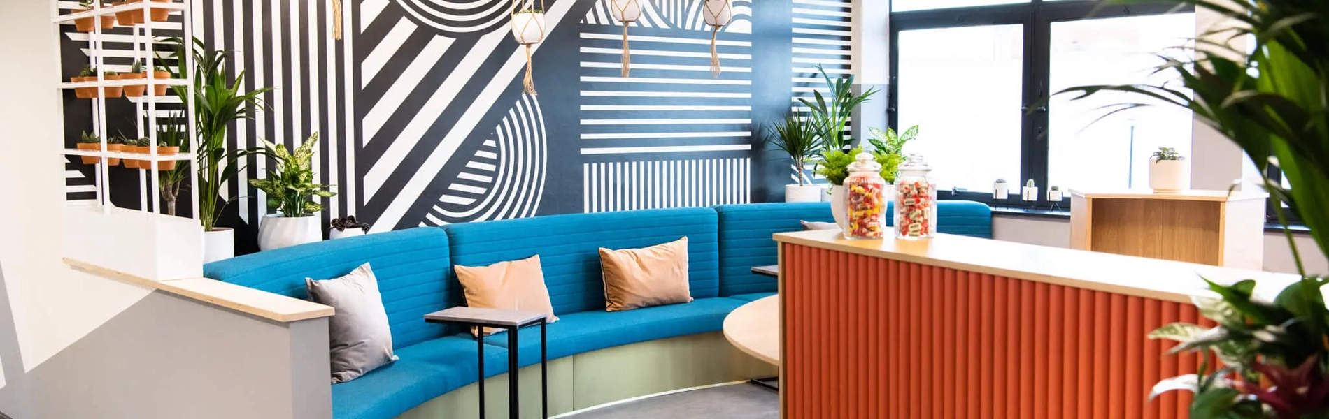 A reception area with chairs and a workstation. 