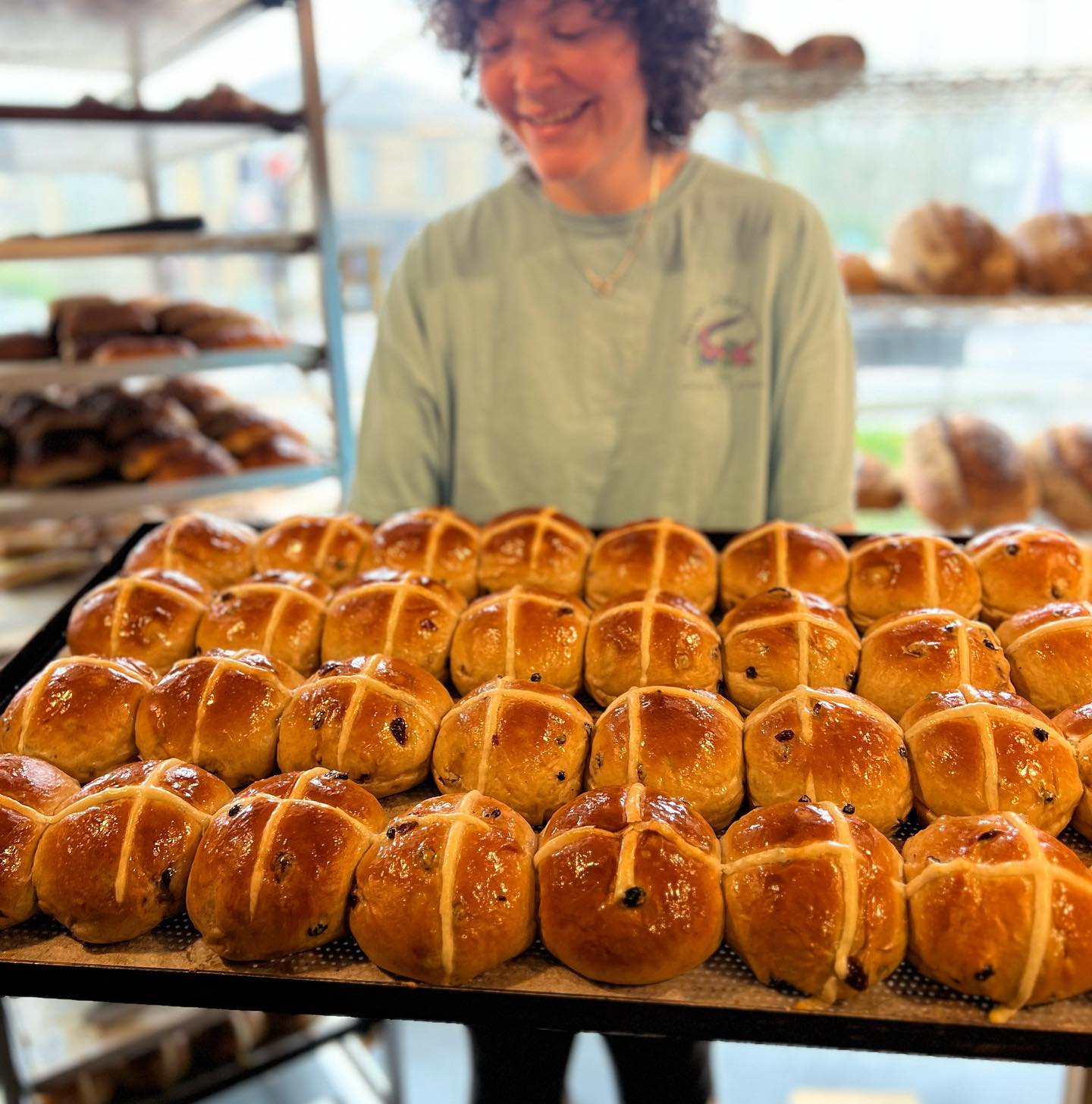 A tray of hot cross buns, fresh out of the oven.