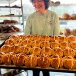 A tray of hot cross buns, fresh out of the oven.