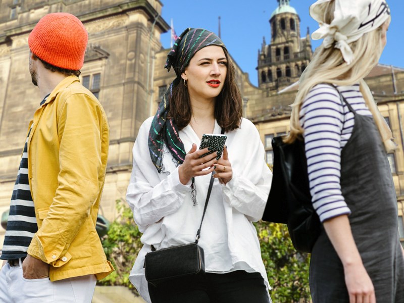 Three people having fun on a treasure hunt in Sheffield.