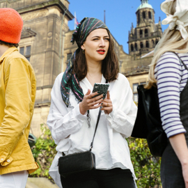 Three people having fun on a treasure hunt in Sheffield.