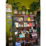 A wooden dresser filled with items for sale in the shop at the Green Light Sanctuary.