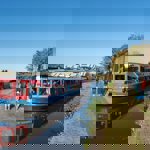 A canal boat motoring along a canal.