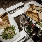 An overhead shot of a table with plates of food at Inox Dine.