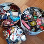 Round tins full of key-rings and badges for sale at The Indie Arcade.